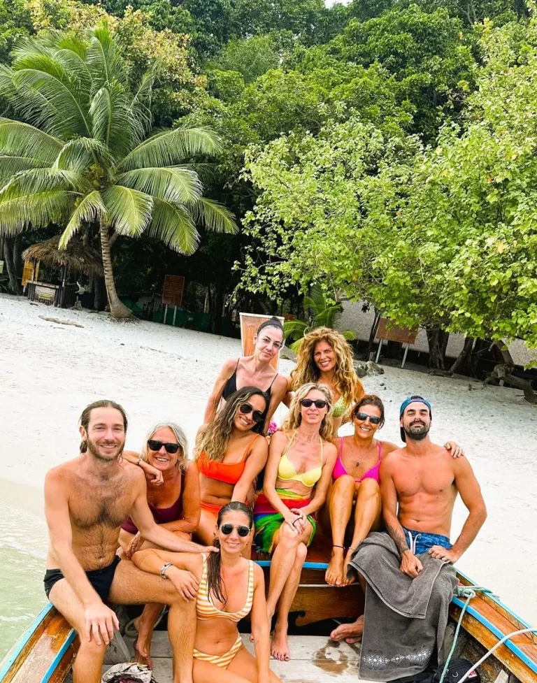 Grupo de viajeros en una barca en la playa